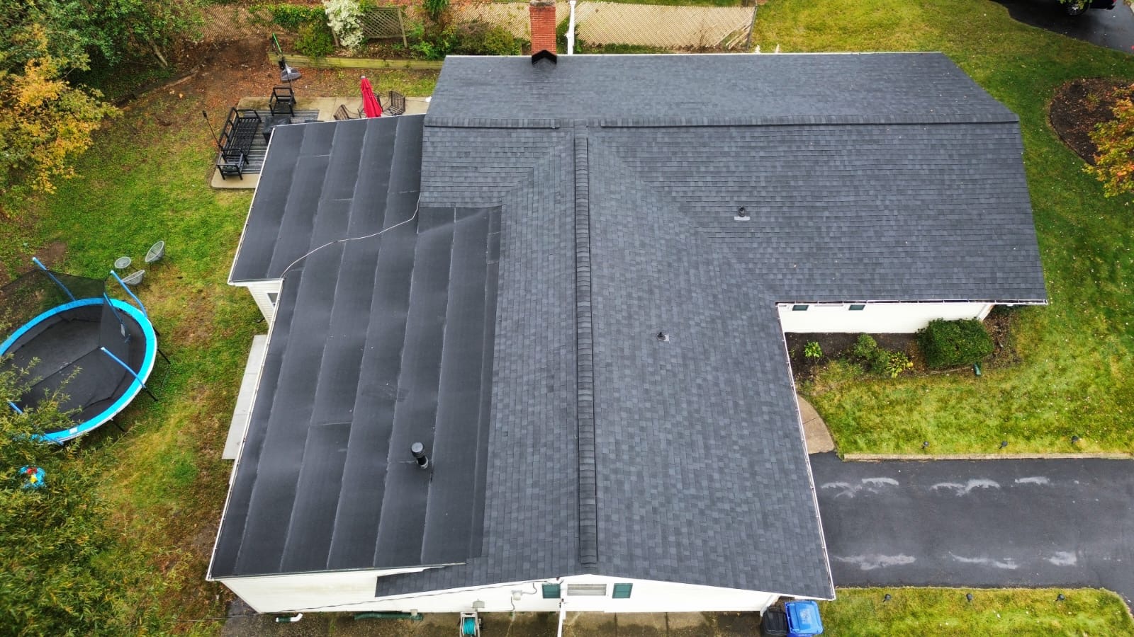 Aerial view of the finished roof replacement — new architectural shingles installed across the full multi-gable roofline